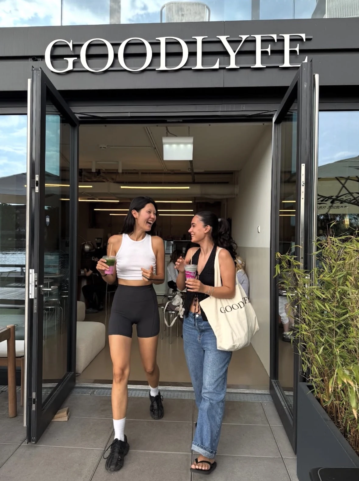 Goodlyfe — Guests with drinks at the Goodlyfe entrance