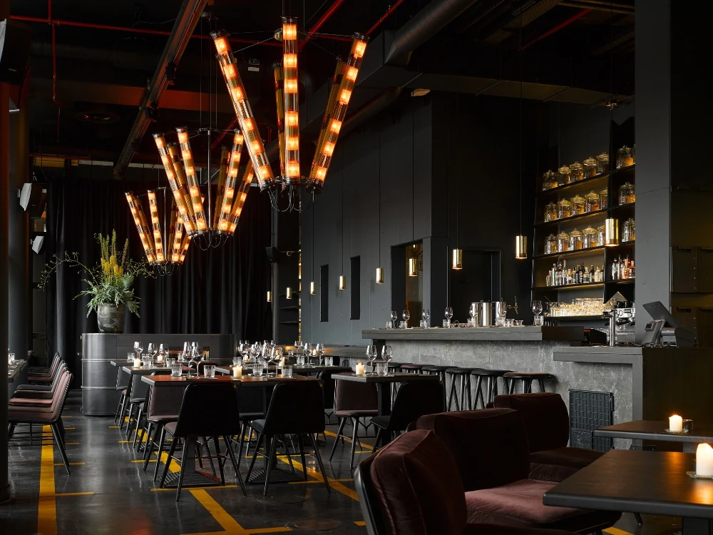 Set tables and warm pendant lights in Heimat Restaurant