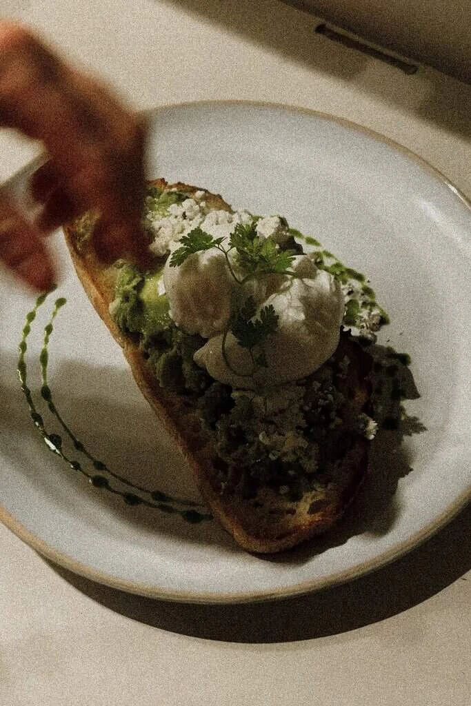 Breakfast toast with poached eggs and herbs at Marshall Street Coffee