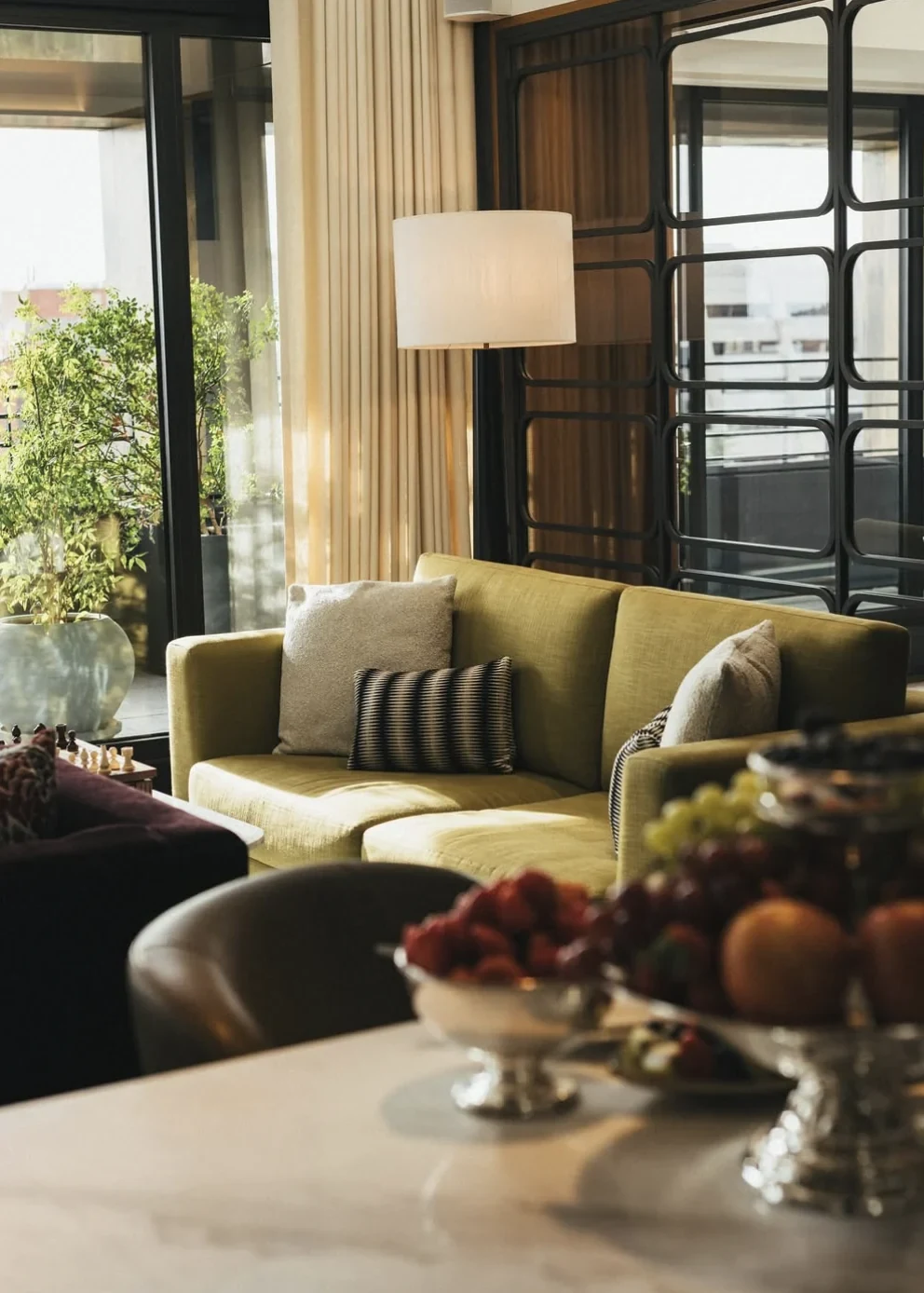 Rosewood Villa Magna — Hotel lounge with a green sofa